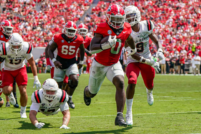 Sep 9, 2023; Athens, Georgia, USA; Georgia Bulldogs running back Roderick Robinson II (0) runs past Ball State Cardinals linebacker Keiont Newson (9) to score a touchdown against the Ball State Cardinals during the second half at Sanford Stadium.